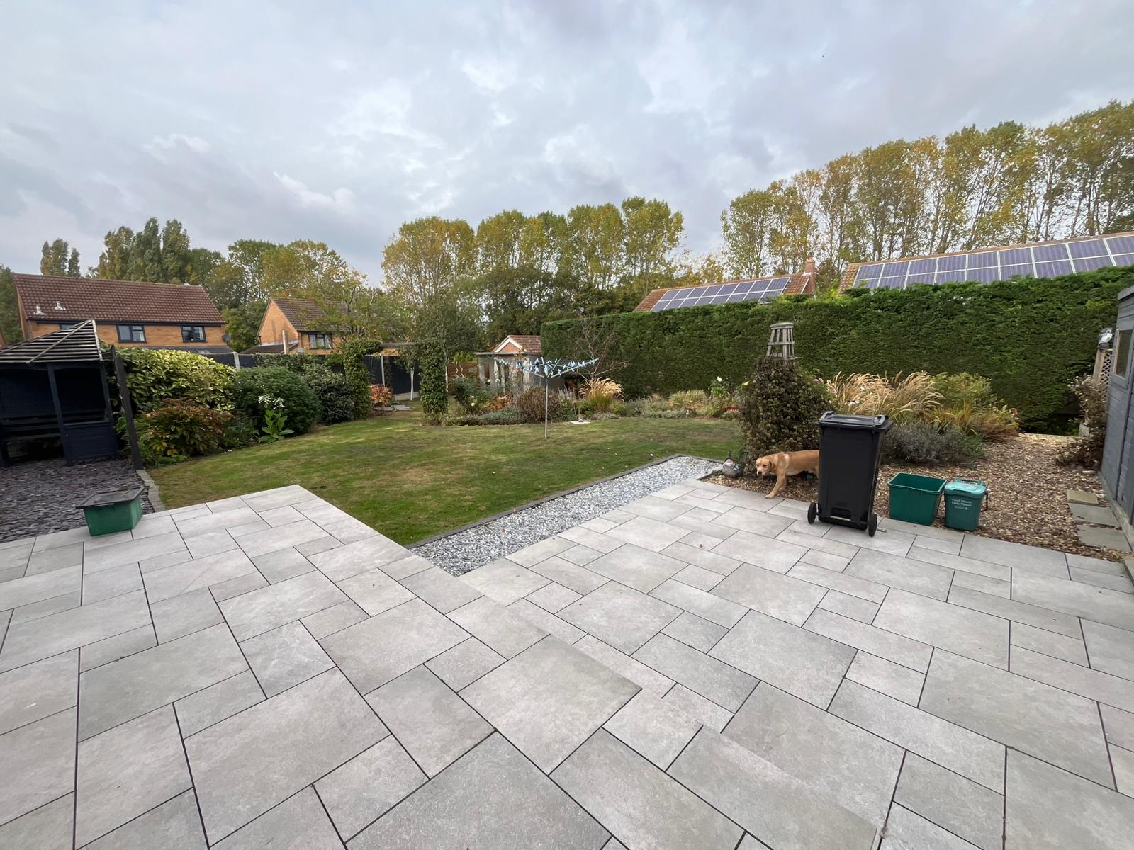 Large grey porcelain patio stepping down from a back door.